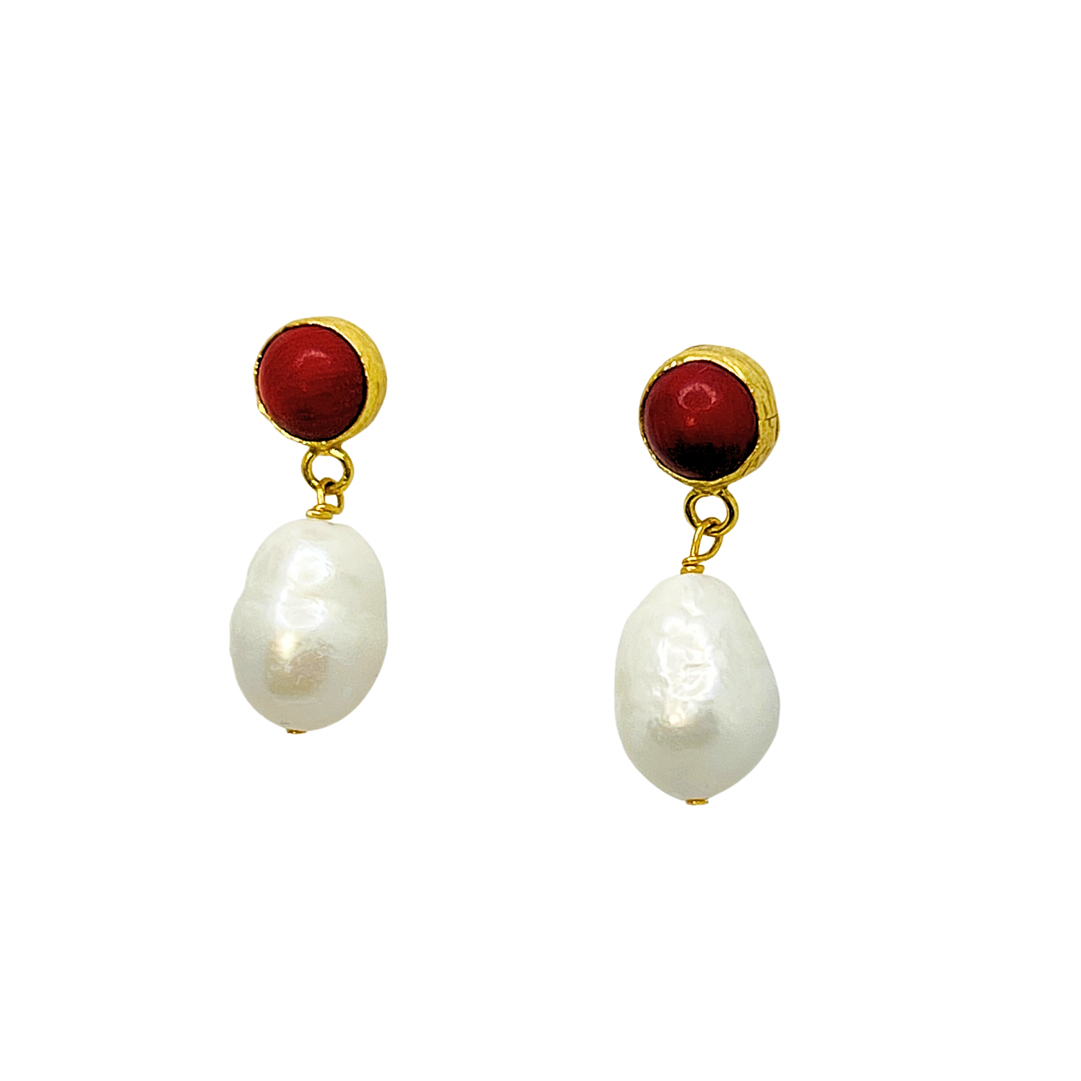 Pair of earrings with red gemstones and pearl-like beads on a white background