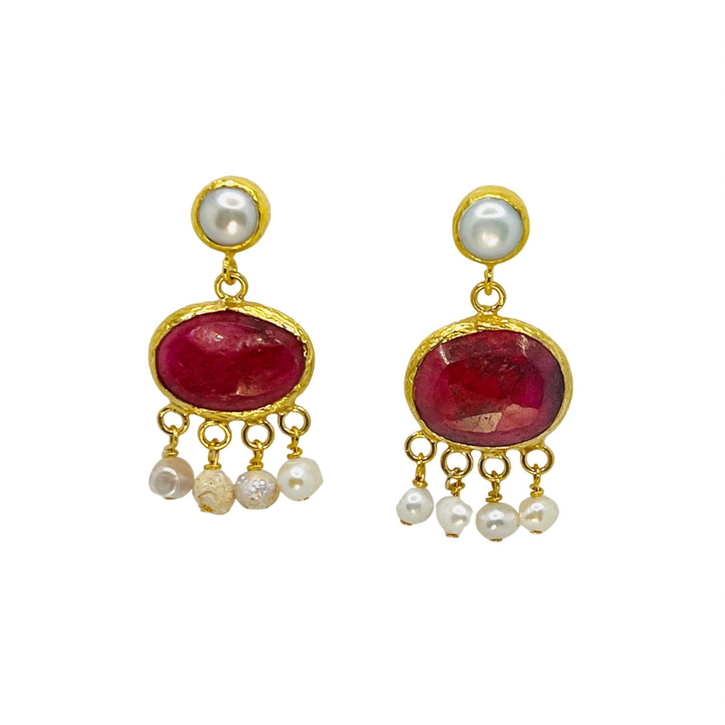 Pair of earrings with red stones and pearl drops on a white background