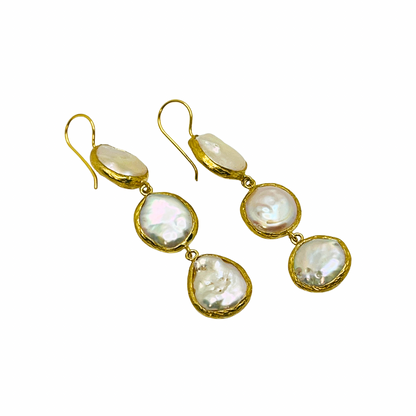 Gold earrings with multiple pearl-like stones on a white background